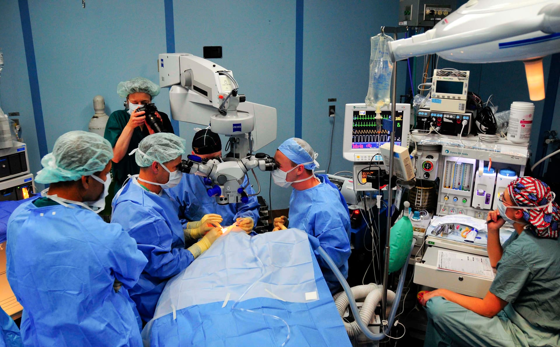 Operating room photo of eye surgery under a microscope