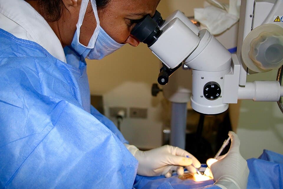 Ophthalmologist performing an intravitreal injection using a microscope